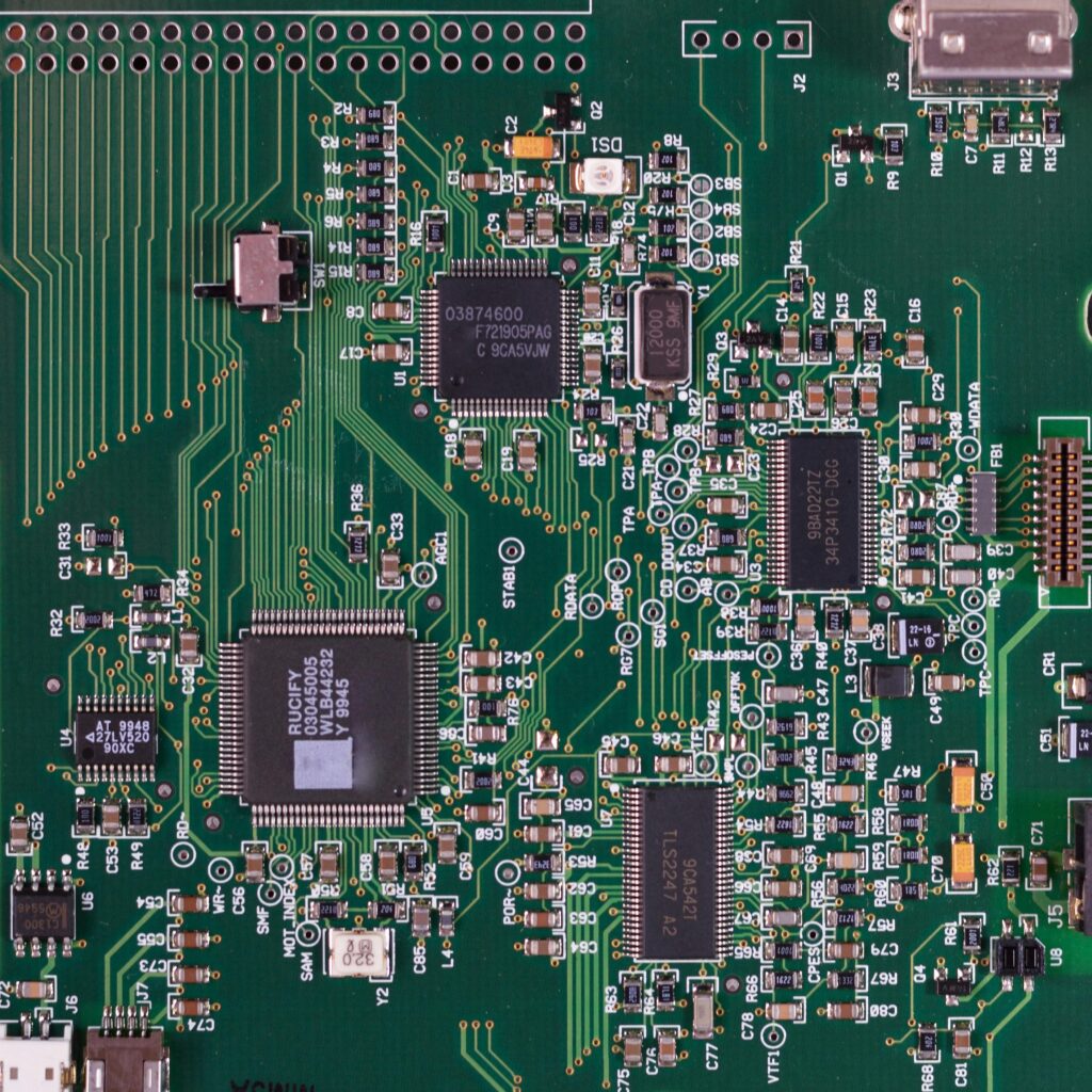 pexels photo 343457 343457 Detailed image of a green circuit board featuring various components and microprocessors.