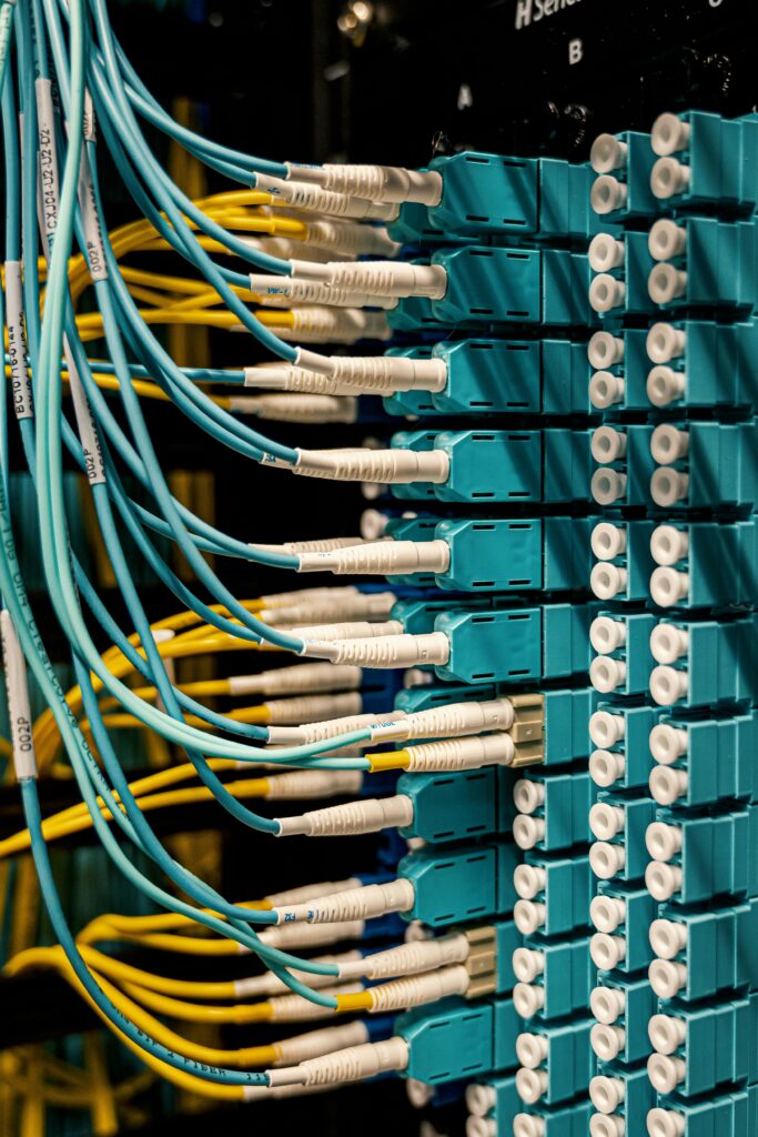 pexels photo 4497197 4497197 Blue and yellow optical fiber cables connected to ports in a server room.